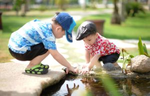 children playing in small pond