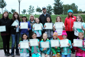 Girl Scout Troop 1683 poses for a photo with certificates of acheivement after the hard work they put in for Inspiration Playground